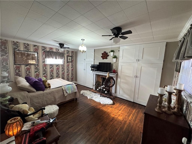 bedroom featuring dark wood-style floors, crown molding, and wallpapered walls