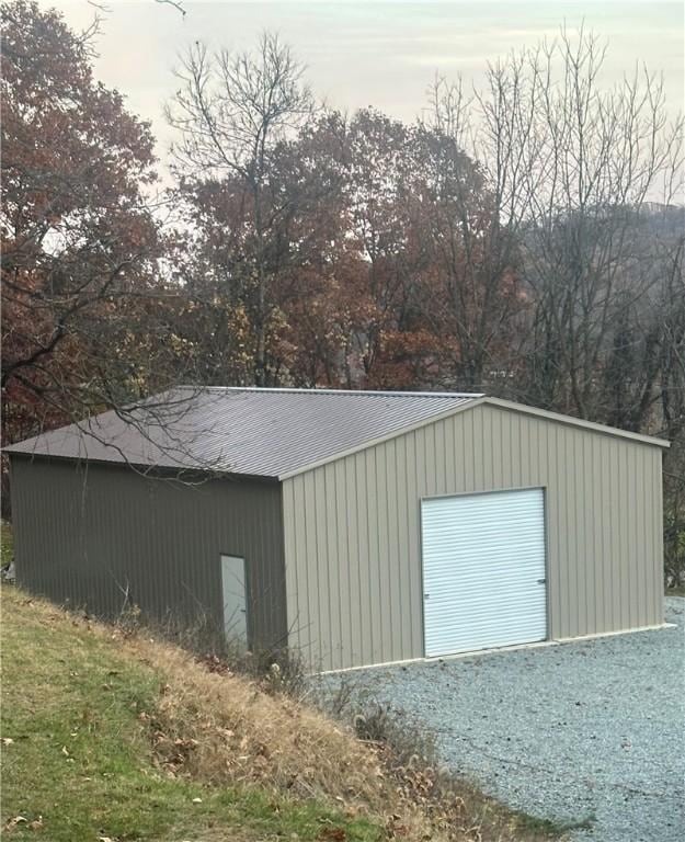 view of outbuilding featuring gravel driveway and an outdoor structure