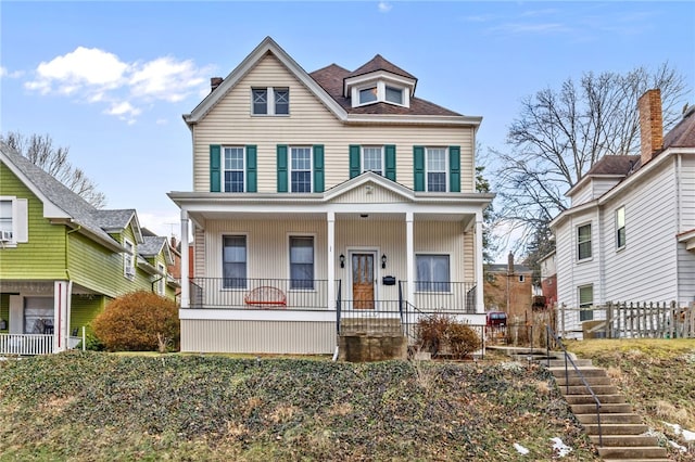 view of front of property with a porch and a shingled roof