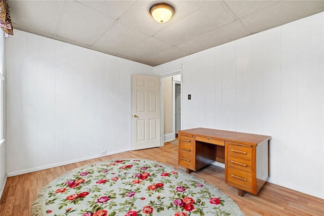 home office with light wood-style floors and baseboards