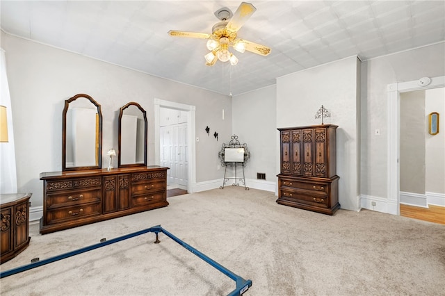 bedroom featuring a ceiling fan, carpet, connected bathroom, and baseboards