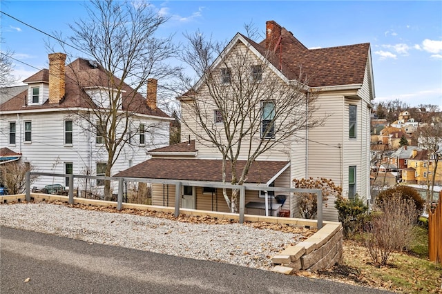 view of front of home with a shingled roof