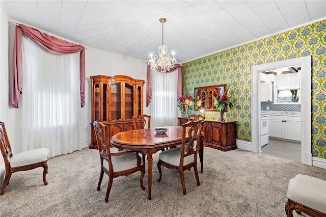 dining room featuring a notable chandelier, baseboards, light colored carpet, and wallpapered walls