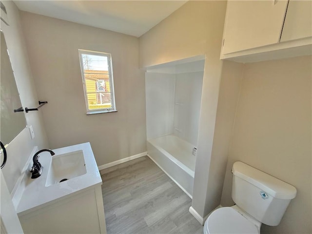 full bathroom featuring baseboards, vanity, toilet, and wood finished floors