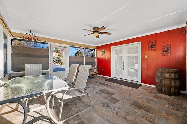 sunroom featuring a ceiling fan and french doors