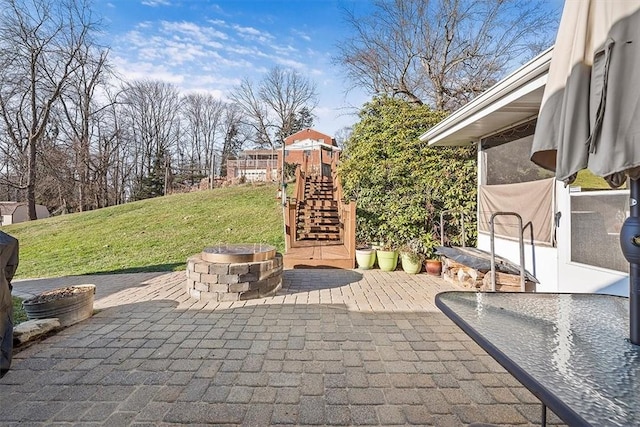 view of patio with stairs and an outdoor fire pit