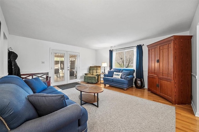 living area with light wood-type flooring and french doors