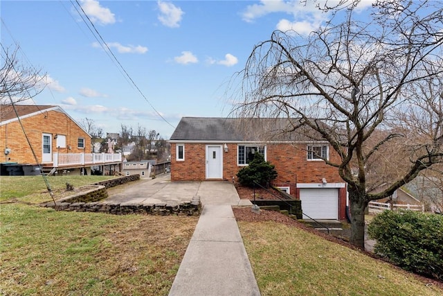 view of front of property with a garage, driveway, a front lawn, and brick siding