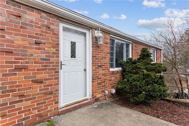 entrance to property with brick siding