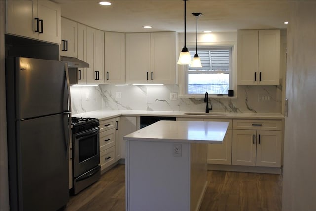 kitchen with black range with gas cooktop, white cabinets, freestanding refrigerator, under cabinet range hood, and a sink