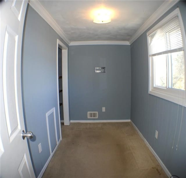 unfurnished room with ornamental molding, visible vents, and baseboards