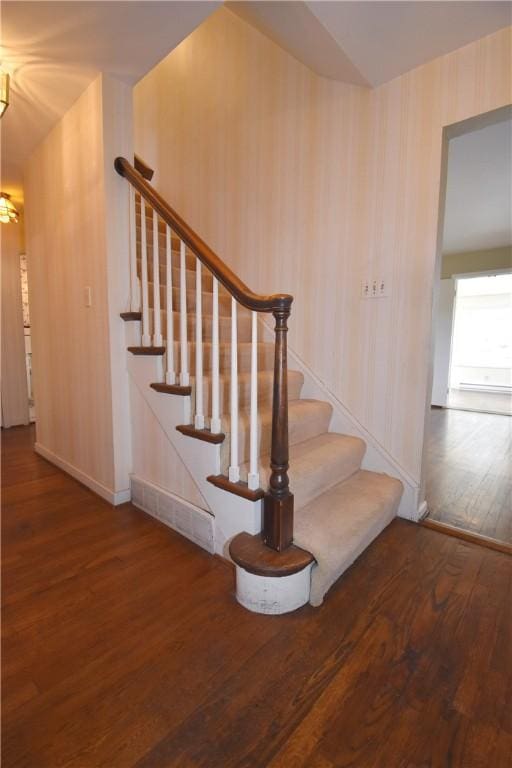 staircase featuring wood finished floors