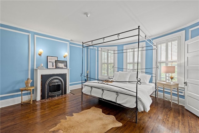 bedroom with multiple windows, wood finished floors, and crown molding