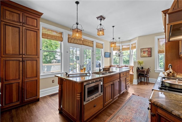 kitchen featuring stainless steel appliances, dark wood-style flooring, a sink, and french doors