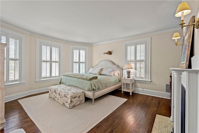 bedroom featuring baseboards, multiple windows, ornamental molding, and dark wood-style flooring