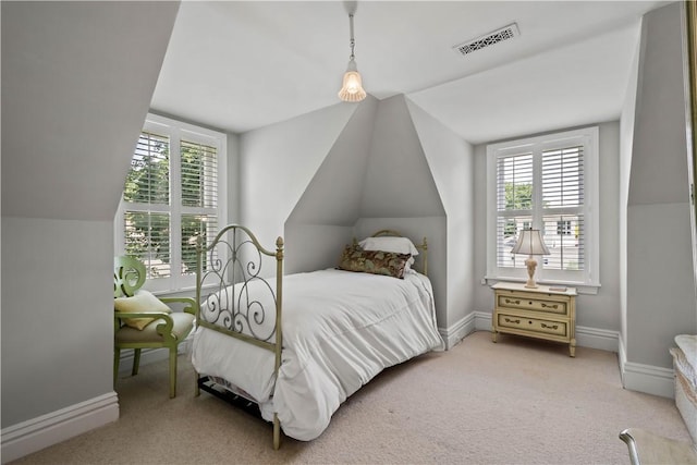 bedroom with light carpet, vaulted ceiling, visible vents, and baseboards