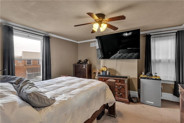 bedroom with baseboards, visible vents, ceiling fan, crown molding, and carpet flooring