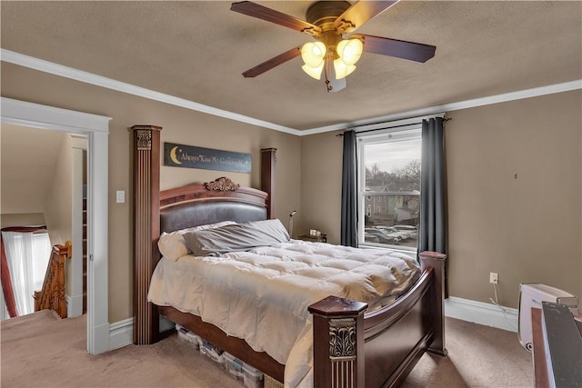 carpeted bedroom with ornamental molding and a textured ceiling