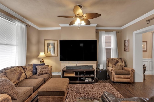 living room with a ceiling fan, crown molding, and wood finished floors