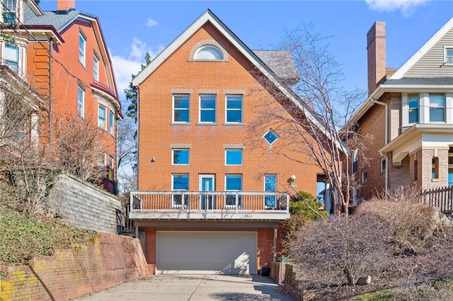 view of front facade with an attached garage, concrete driveway, and brick siding