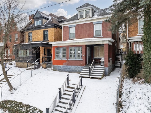 traditional style home featuring stairway and brick siding