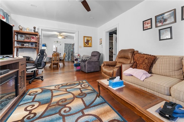 living area with ceiling fan and wood finished floors