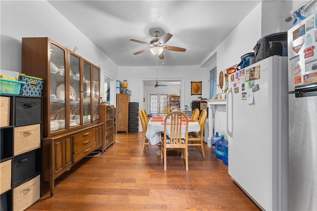 dining space featuring a ceiling fan and wood finished floors