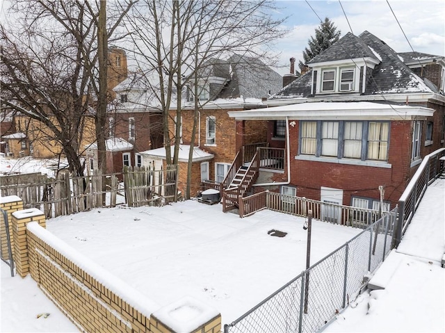 view of front of property featuring brick siding and fence