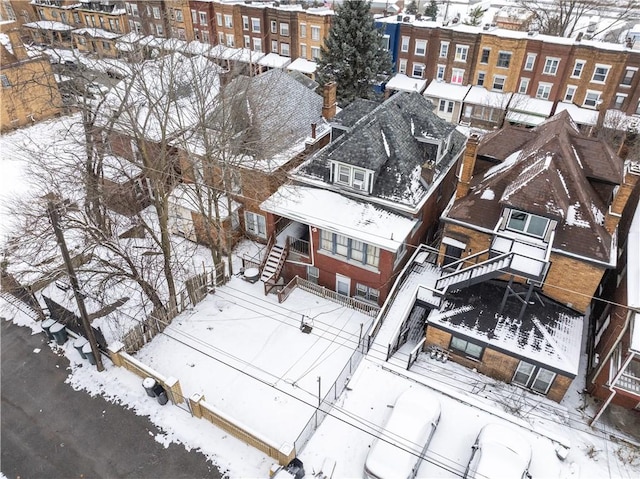 snowy aerial view with a residential view