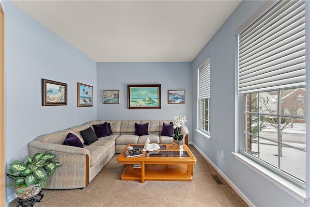 carpeted living area with visible vents and baseboards