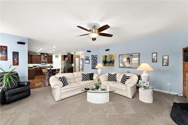 carpeted living area with ceiling fan, baseboards, and recessed lighting