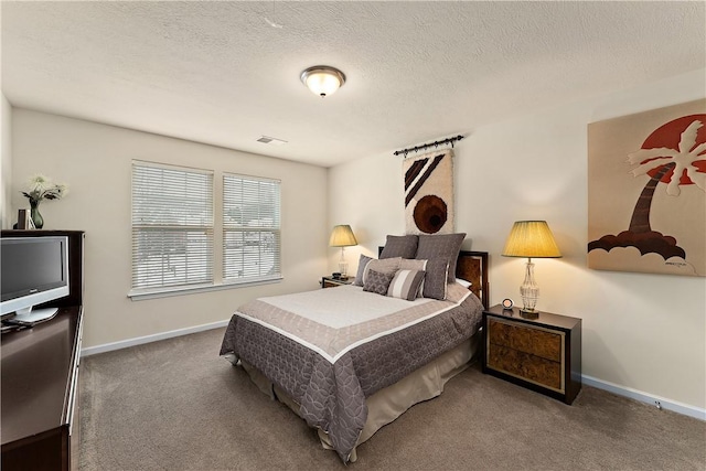 carpeted bedroom featuring a textured ceiling, visible vents, and baseboards