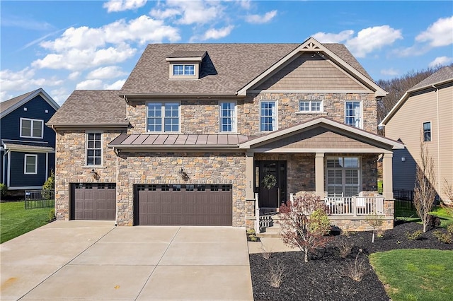 craftsman house featuring covered porch, a standing seam roof, metal roof, a garage, and driveway