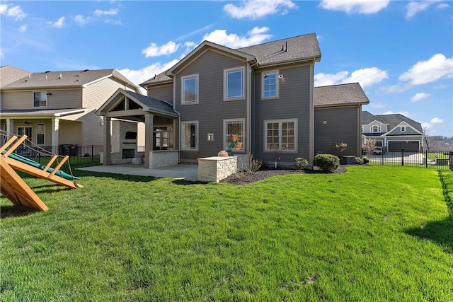 rear view of house featuring a patio area, a fenced backyard, a playground, and a yard