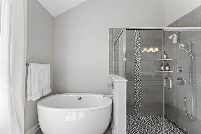 full bathroom with a soaking tub and a shower stall