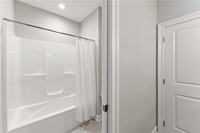 bathroom with recessed lighting and shower / tub combo with curtain