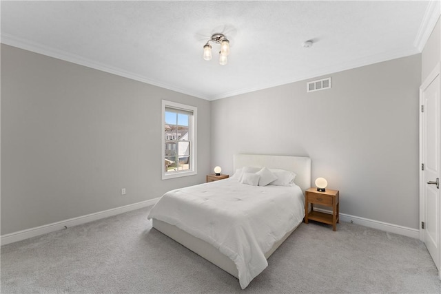 carpeted bedroom featuring ornamental molding, visible vents, and baseboards