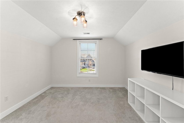 bonus room featuring carpet floors, baseboards, visible vents, and lofted ceiling