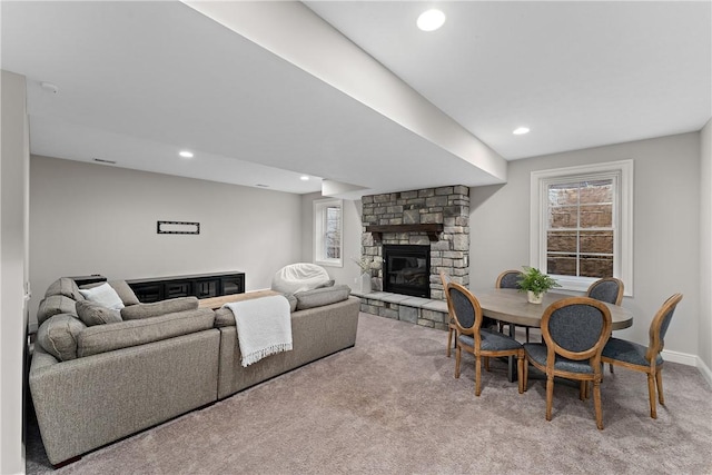 carpeted living area with recessed lighting, a healthy amount of sunlight, a fireplace, and baseboards