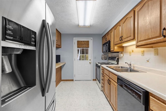 kitchen featuring white range with gas cooktop, dishwasher, light countertops, stainless steel refrigerator with ice dispenser, and a sink