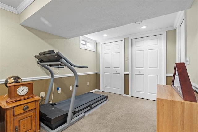 workout area featuring light carpet, baseboards, crown molding, and recessed lighting