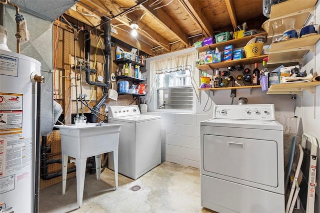 laundry area featuring water heater, laundry area, separate washer and dryer, and concrete block wall