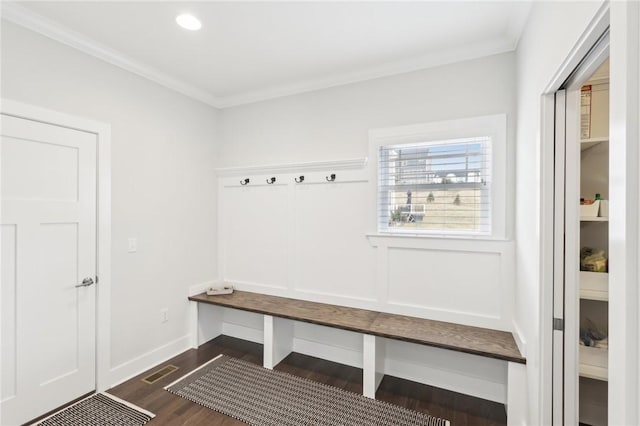 mudroom featuring dark wood finished floors, visible vents, crown molding, and baseboards