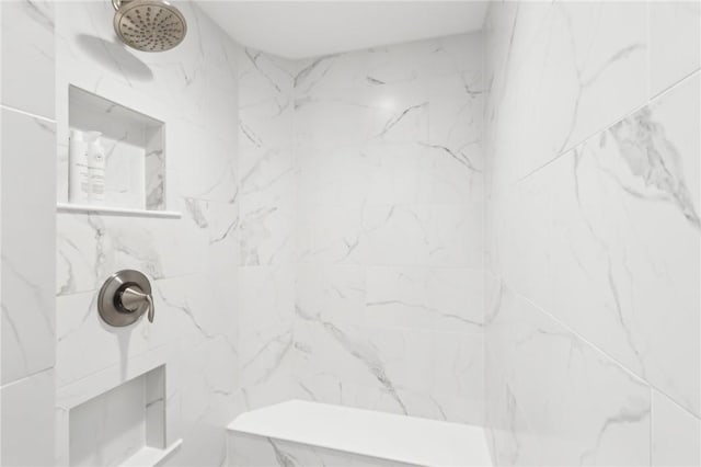 bathroom with a marble finish shower