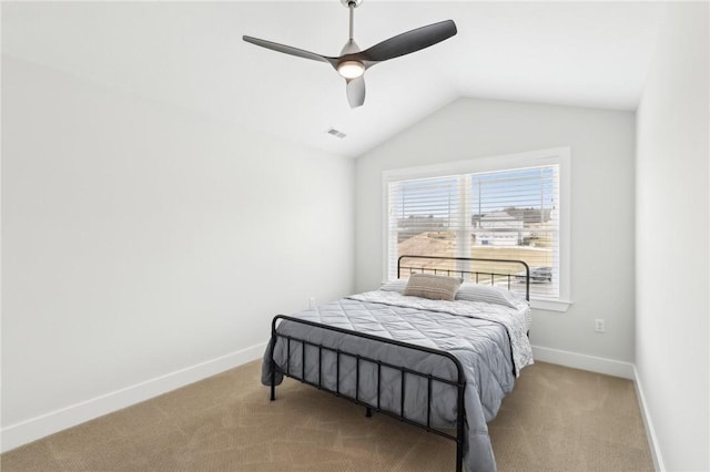 carpeted bedroom featuring lofted ceiling, ceiling fan, visible vents, and baseboards