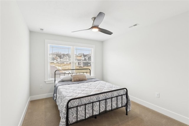 bedroom with carpet floors, baseboards, and visible vents