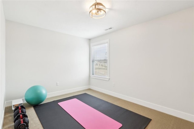 workout area with carpet, visible vents, and baseboards