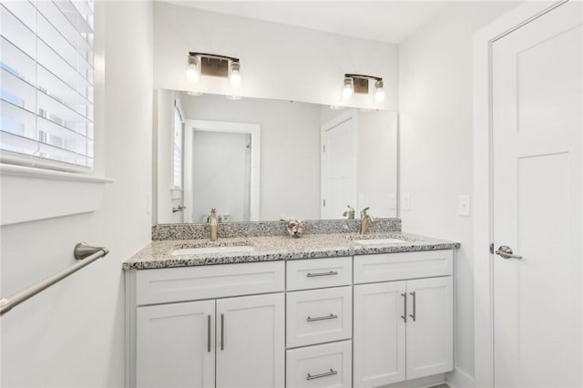 bathroom featuring double vanity and a sink