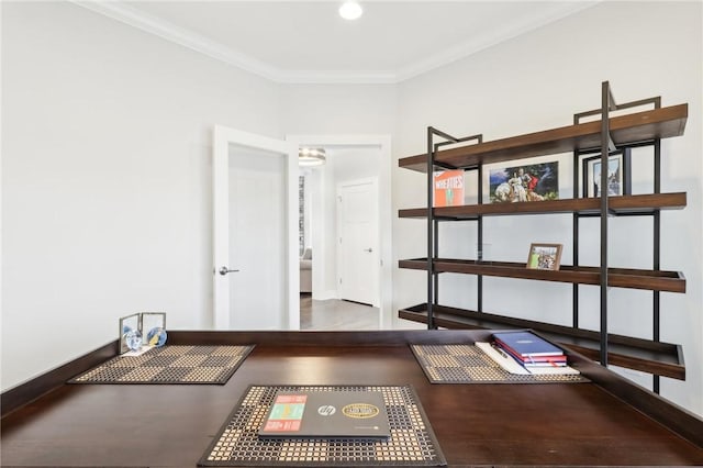 office area featuring baseboards, wood finished floors, and crown molding