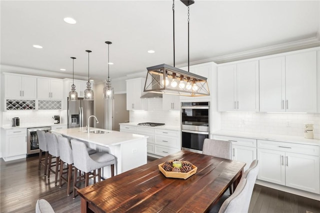 dining space featuring ornamental molding, wine cooler, dark wood-style flooring, and recessed lighting